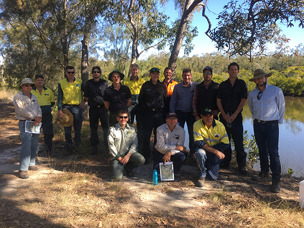 Prescribed burning practitioners near fishing hole in queensland